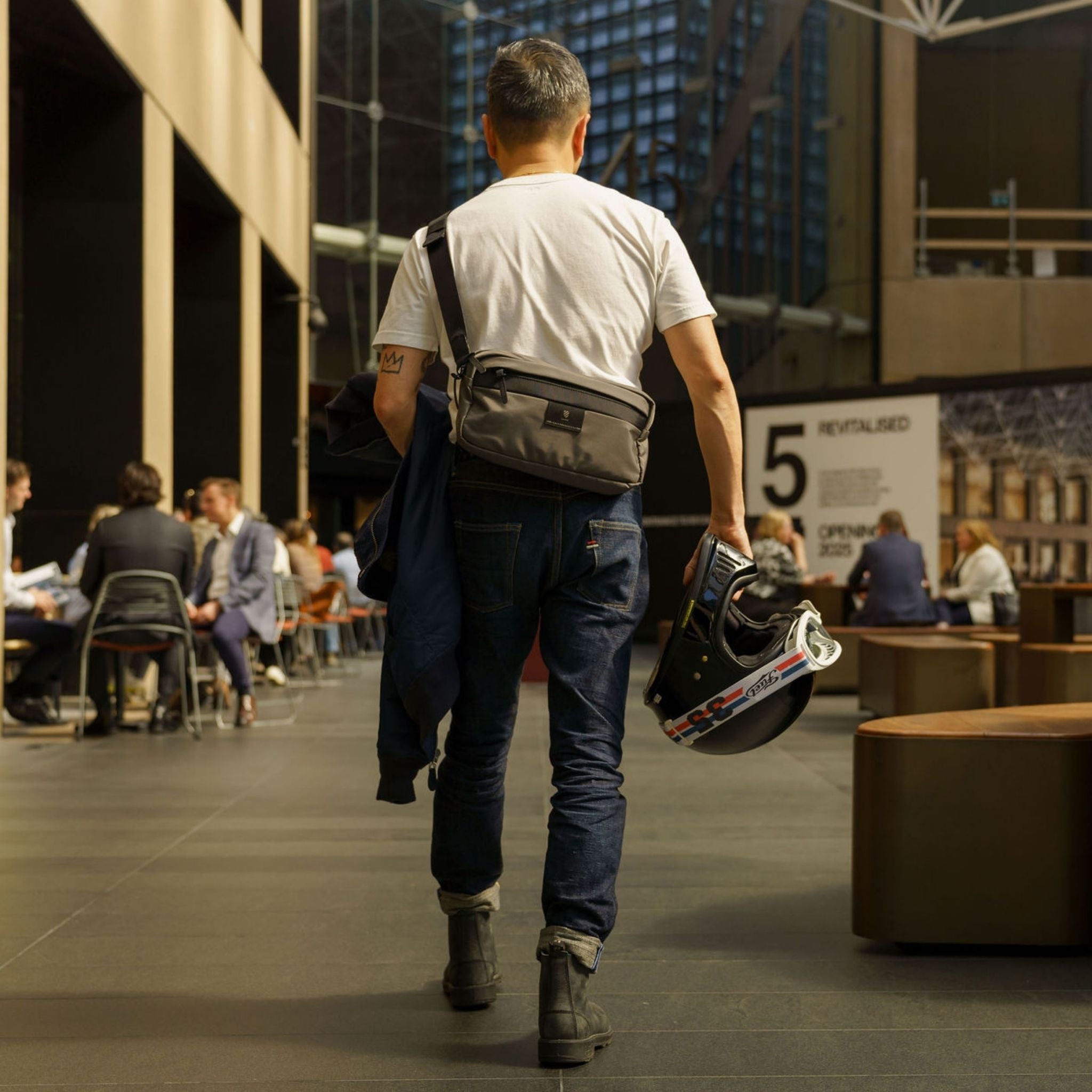 Man walking with new Langly Everyday Sling Bag
